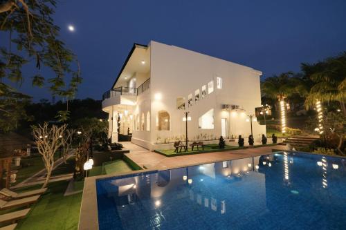 a villa with a swimming pool at night at Flamingo Aquila in Badung