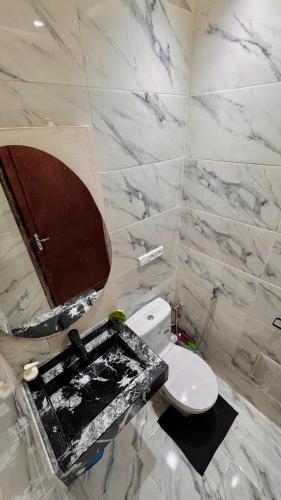 a bathroom with a white toilet and a sink at Appartement near to AirPort 262 avenue el khalij 2 BEDROOM in Marrakech