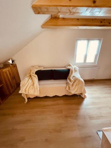 a room with a couch in the corner of a room at Apartman Vito in Kupres