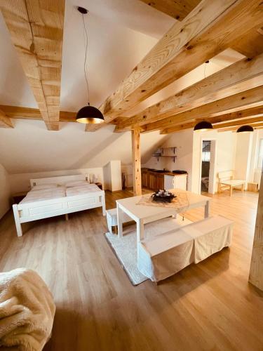 a living room with two beds and a table at Apartman Vito in Kupres