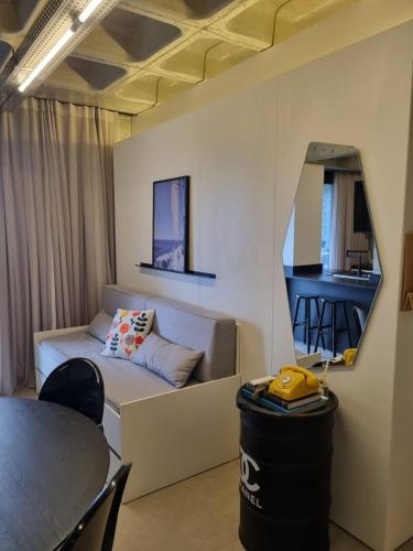 a living room with a couch and a table at Loft Industrial - Edifício Vista Mare apto novo in Torres