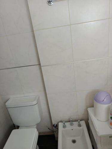 a small bathroom with a toilet and a sink at Villa Lastenia in San Salvador de Jujuy