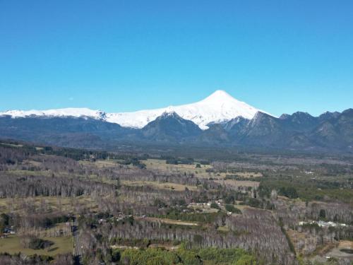 an aerial view of a snow covered mountain at Boker Tov Pucón in Pucón