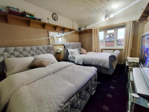 a hotel room with two beds and a window at Clayton Home in Manchester