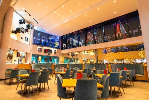 a restaurant with tables and chairs in a building at Aloft Ponce Hotel & Casino in Ponce