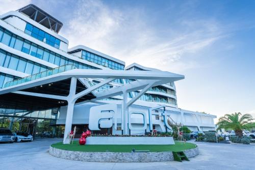 a large building with a sign in front of it at Aloft Ponce Hotel & Casino in Ponce