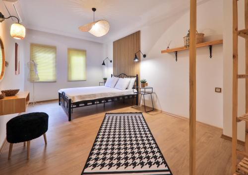 a bedroom with a bed and a table and a chair at Nodus Tollens Apart in Kaş