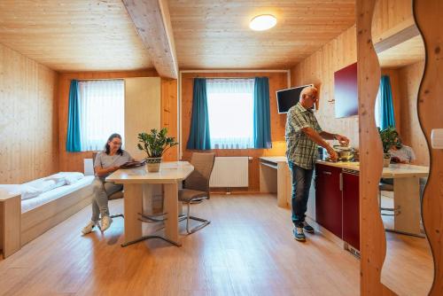 a man and a woman in a kitchen in a room at Gästehaus Aquilin in Sankt Pölten