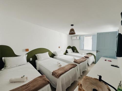 a row of beds in a room at Pousada Vilab in Arraial d'Ajuda