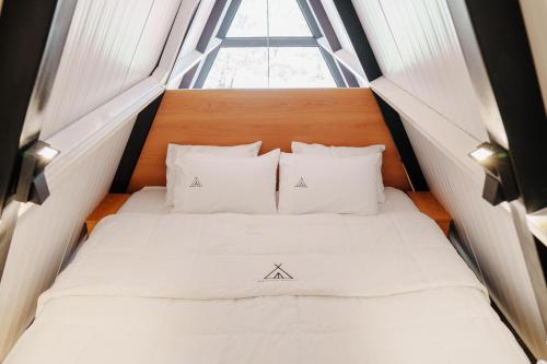 a bed in a small room with a window at Cabana BlackRock in São João da Aliança