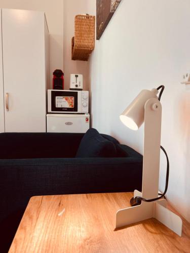 a lamp sitting on top of a wooden floor in a room at ONE Guest Place Private Bedroom with Balcony in Abu Dhabi