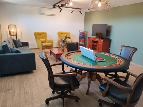 a living room with a table with a laptop on it at Villa Zéta Wine & Spa in Mád