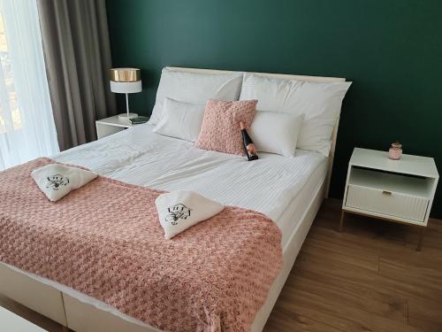 a bedroom with a bed with pillows on it at Villa Zéta Wine & Spa in Mád