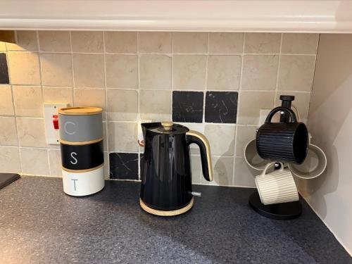 two coffeemakers sitting on a counter next to a coffee maker at Room at quiet location close to Belfast in Carnmoney