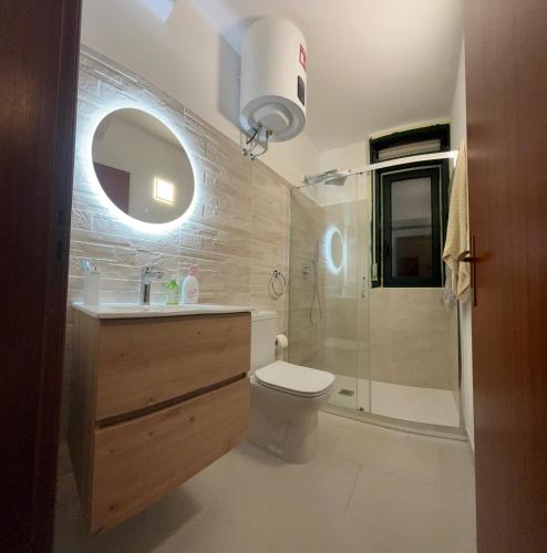 a bathroom with a toilet and a sink and a shower at Casa Jaya Taormina in Taormina