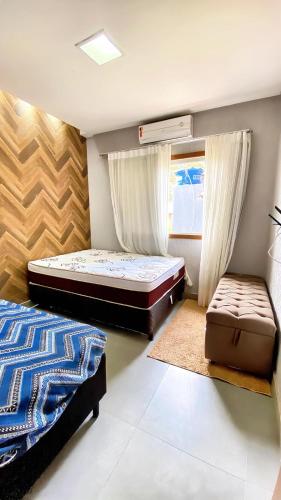a bedroom with two beds and a suitcase in it at CasaBelgaBrasil in Prado