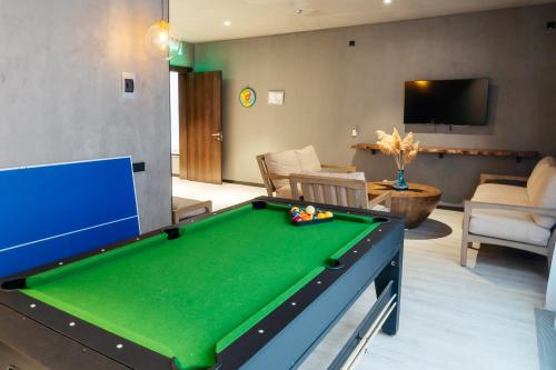 a living room with a pool table and a tv at SULO VIP Spa in Atyraū