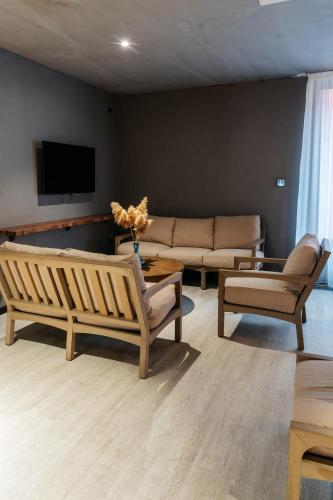 a living room with a couch and two chairs at SULO VIP Spa in Atyraū