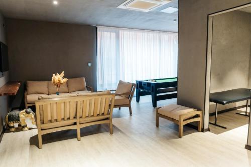 a living room with a couch and a pool table at SULO VIP Spa in Atyraū