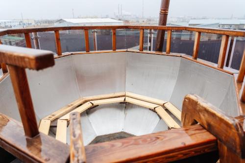 a wooden bench sitting on a deck of a boat at SULO VIP Spa in Atyraū