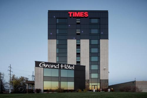 a building with a sign on top of it at Grand Times Hotel in Quebec City
