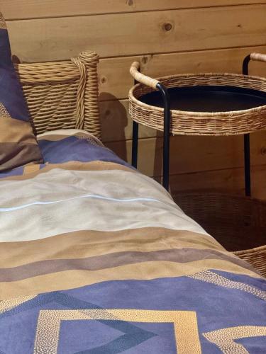 a bed with wicker chairs in a room at Maison Boho Kremna in Durdići