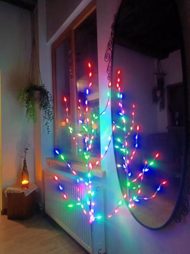 a room with a mirror with christmas lights at STĀRĶA APARTAMENTI in Kuldīga