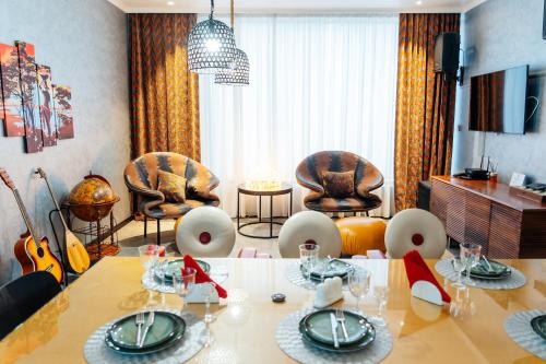 a living room with a dining table and chairs at SULO VIP Spa in Atyraū
