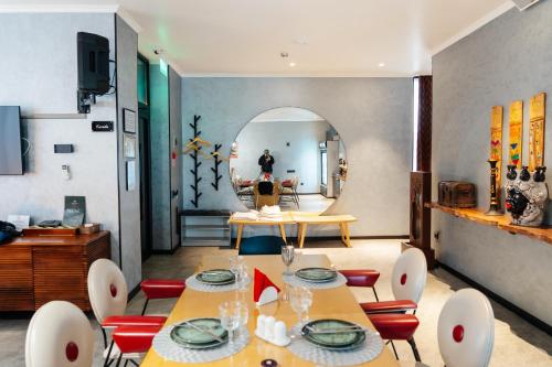 a dining room with tables and chairs and a mirror at SULO VIP Spa in Atyraū