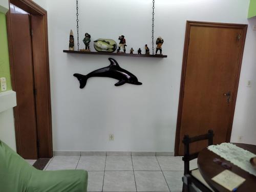 a living room with a dolphin on the wall at Apartamento, Praia Grande, Canto do Forte in Praia Grande