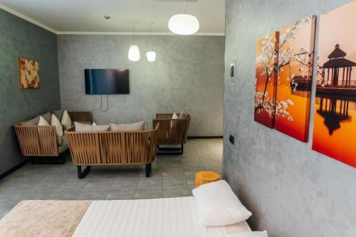 a room with a living room with a couch and a tv at SULO VIP Spa in Atyraū