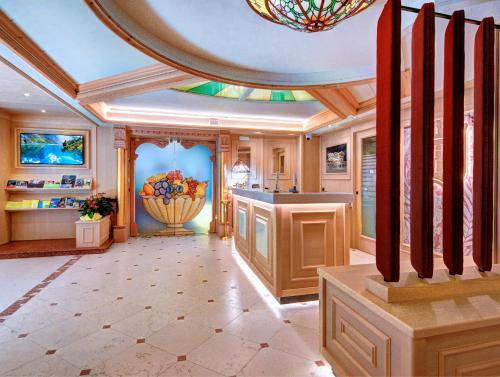 a large kitchen with a ceiling and a chandelier at Hotel Madonna delle Nevi in Folgarida