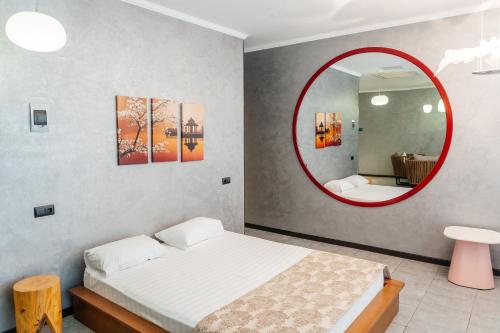 a bedroom with a bed and a red mirror at SULO VIP Spa in Atyraū