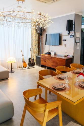 a living room with a table and chairs at SULO VIP Spa in Atyraū