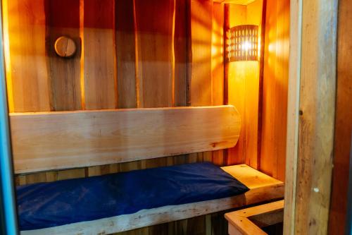 a small wooden cabin with a blue bed in it at SULO VIP Spa in Atyraū