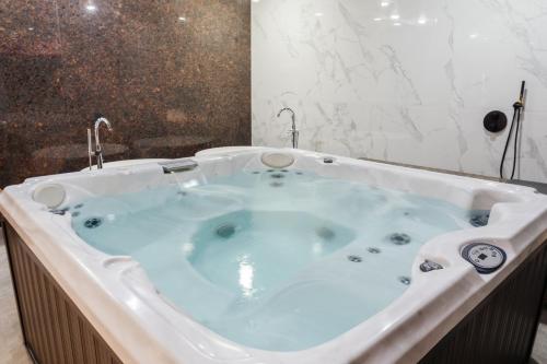 a jacuzzi tub in a bathroom at SULO VIP Spa in Atyraū
