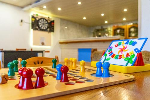 a wooden table with a chess board with figurines on it at Landhaus Familie Allgeier in Holtgast