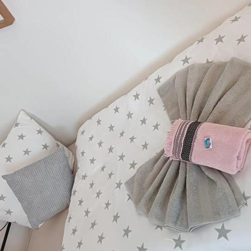 a bed with gray and silver stars on it at Stellas Monteurswohnungen in Crimmitschau