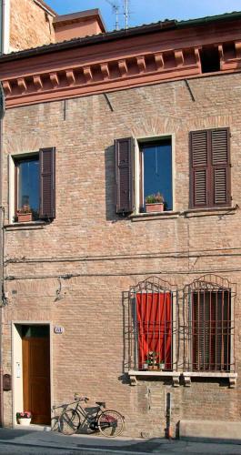 a brick building with a red curtain in a window at Ada B&B in Ferrara
