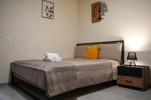 a bedroom with a large bed with an orange pillow at Nastas-Home in Igoumenitsa
