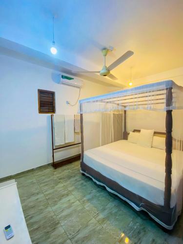 a bedroom with a bed and a ceiling fan at Lake View Villa - Tangalle in Tangalle