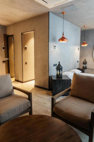 a room with a bed and a couch and a table at SULO VIP Spa in Atyraū