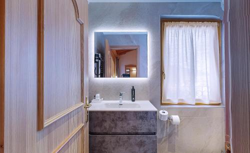 a bathroom with a sink and a mirror at Hotel Madonna delle Nevi in Folgarida