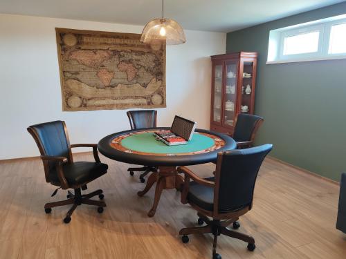 a room with a table with chairs and a laptop on it at Villa Zéta Wine & Spa in Mád
