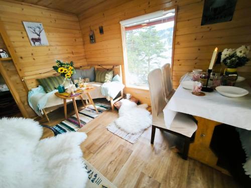 a living room with a table and a dining room at Andrića Sokak 2 in Divčibare