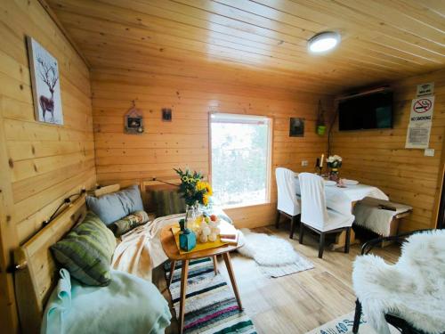 a living room with a couch and a table at Andrića Sokak 2 in Divčibare