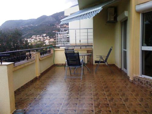 a balcony with chairs and a table on a building at Holiday Home Mikki in Dobra Voda