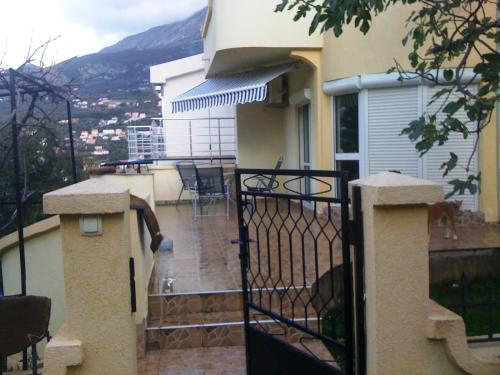 a balcony of a house with a table and chairs at Holiday Home Mikki in Dobra Voda