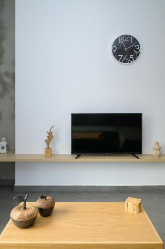 a living room with a table and a tv at Modern Spacious Apartment in Kissamos