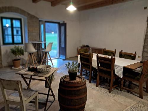 a living room with a table and chairs and a room with a tableablish at Posestvo Brida - Brkini Hills by the Lakes in Ilirska Bistrica